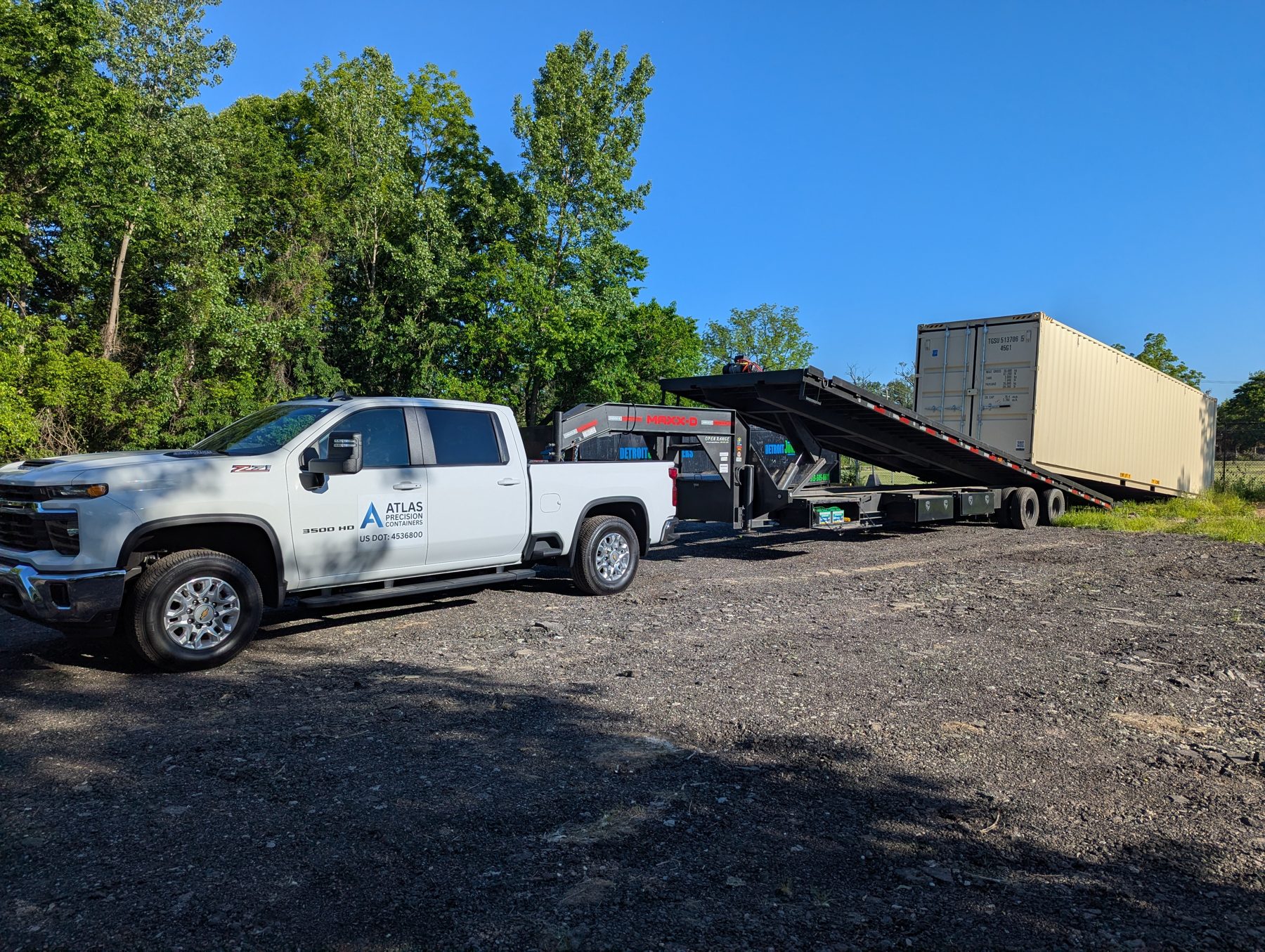 Atlas Precision Containers trailer being loaded with a container