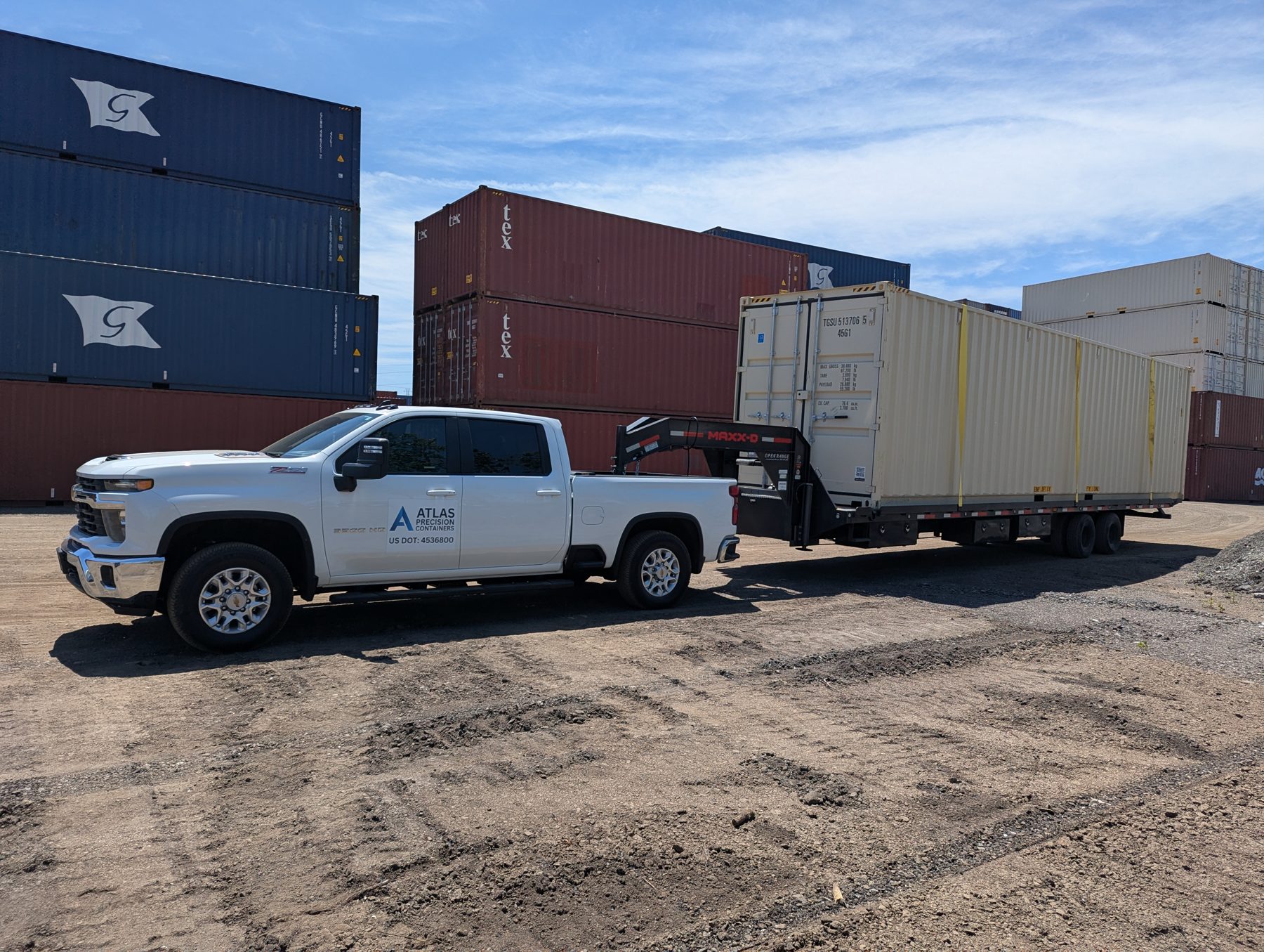 Atlas Precision Containers truck hauling a container out of a depot yard
